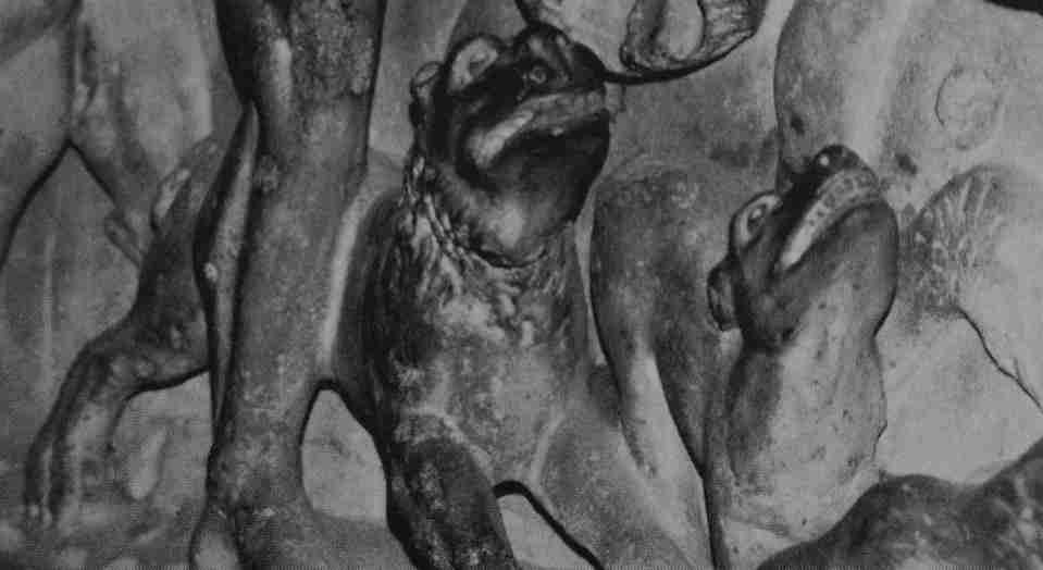Close-up segment of an ancient sculpture depicting Roman soldiers and dogs closely resembling Cani Corsi under foot.